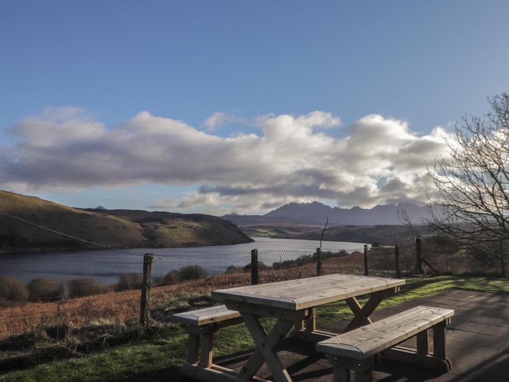 a picnic table with a view of a lake at Arnaval in Fernilea