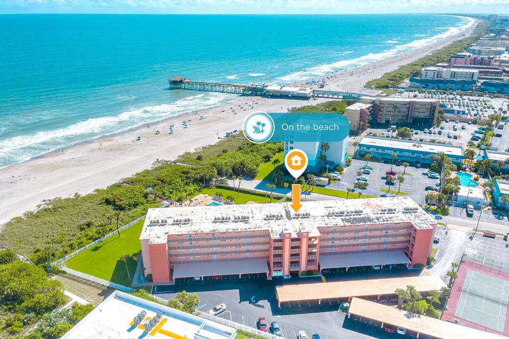 an aerial view of the beach and the ocean at Cocoa Beach Towers - Oceanfront Resort with Heated Pool, Tennis Steps from the Pier in Cocoa Beach