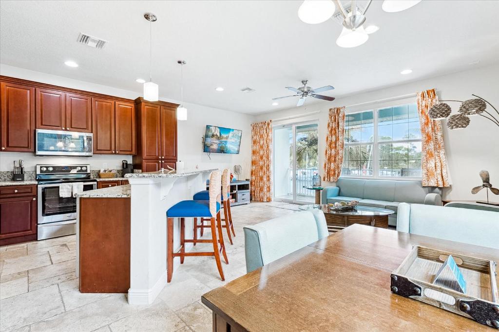 an open kitchen and living room with a counter and chairs at Cape Crossing 106 in Merritt Island
