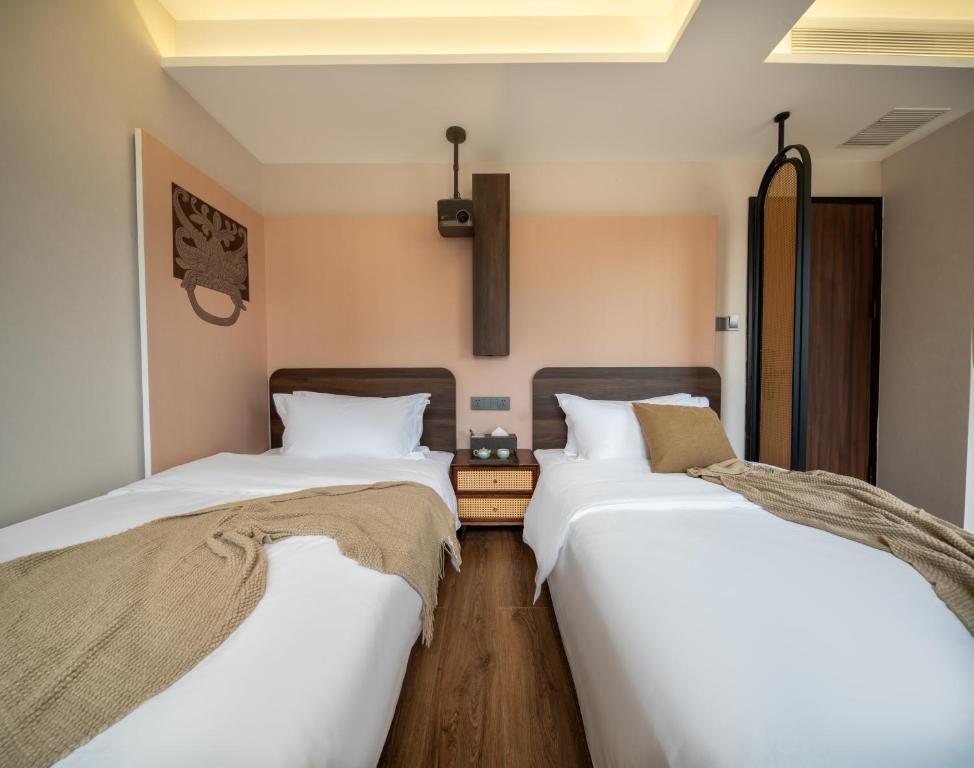 two beds sitting next to each other in a room at Nan she in Datong