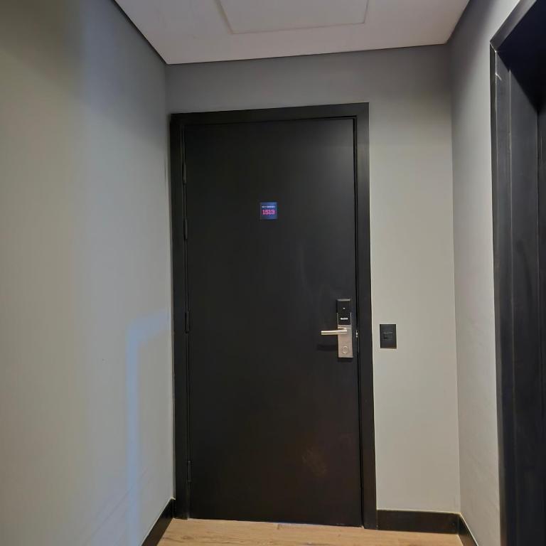 a black door in a building with a sign on it at SKY Alphaville in Barueri