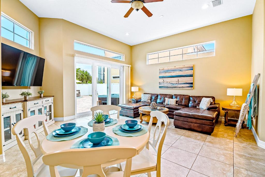 a living room with a table and chairs and a couch at 128 Mediterranean Way in Indian Harbour Beach
