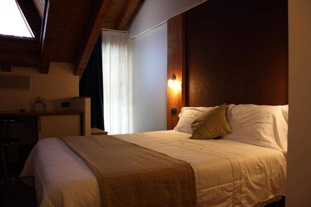 Postel nebo postele na pokoji v ubytování Sole della Franciacorta - Hotel & Restaurant