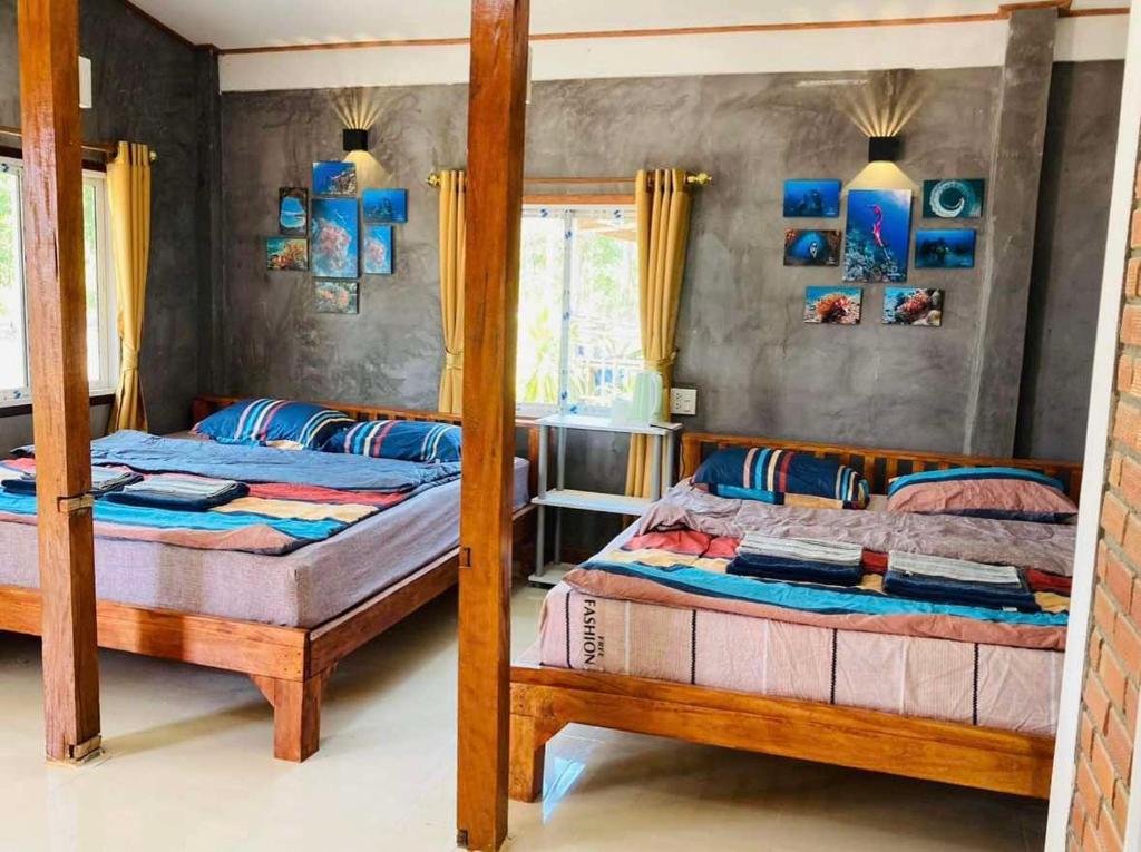 Ένα ή περισσότερα κρεβάτια σε δωμάτιο στο Dansontayakohlibong