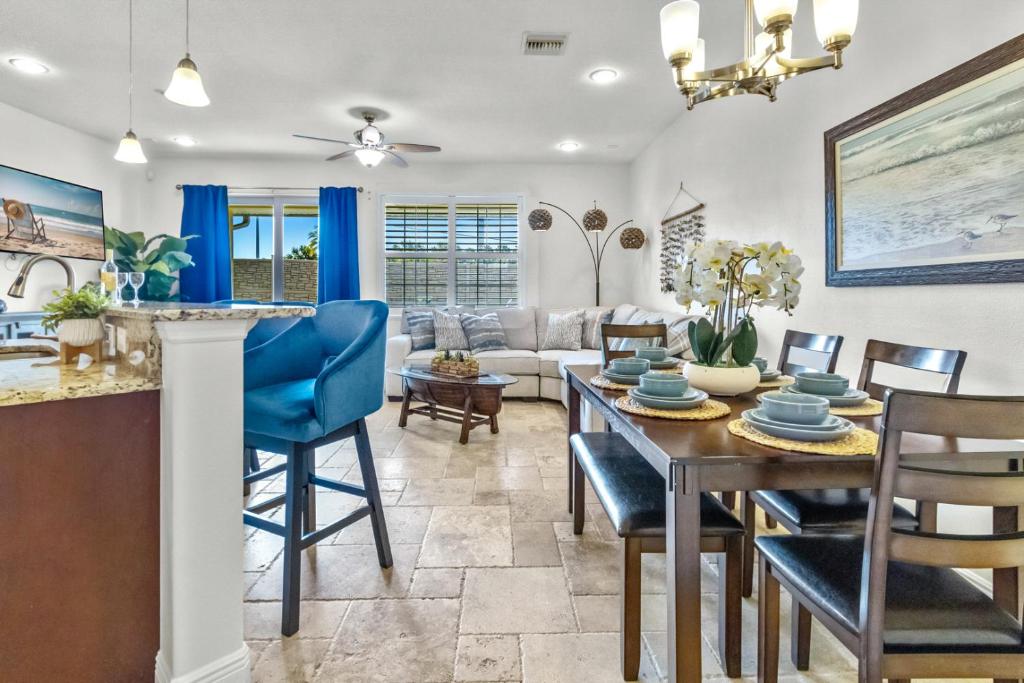 a dining room and living room with a table and chairs at Cape Crossing 104 in Merritt Island