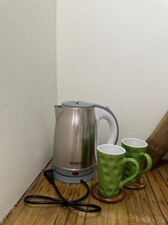 a coffee maker and two cups on a table at Beach Side Cabin San Juan ELYU in San Juan