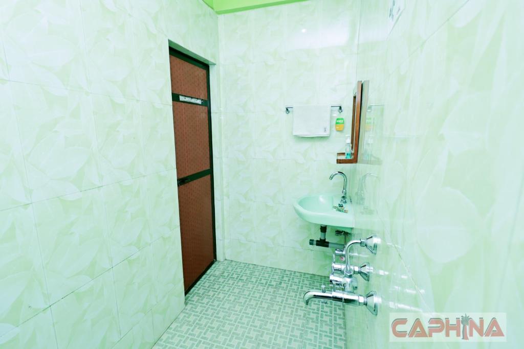 a bathroom with a sink and a shower at Caphina Coastal Comforts in Benaulim