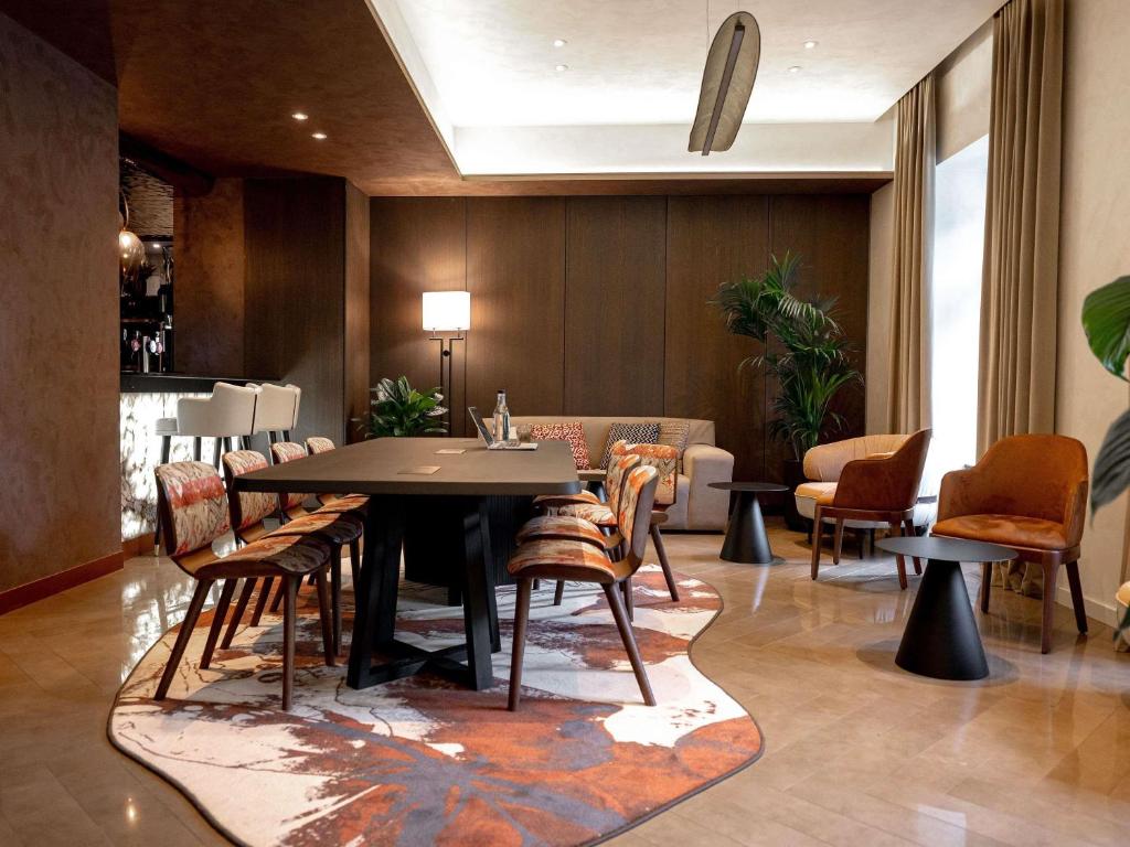 a dining room with a table and chairs at Pullman Riga Old Town - Renovated 2025 in Riga