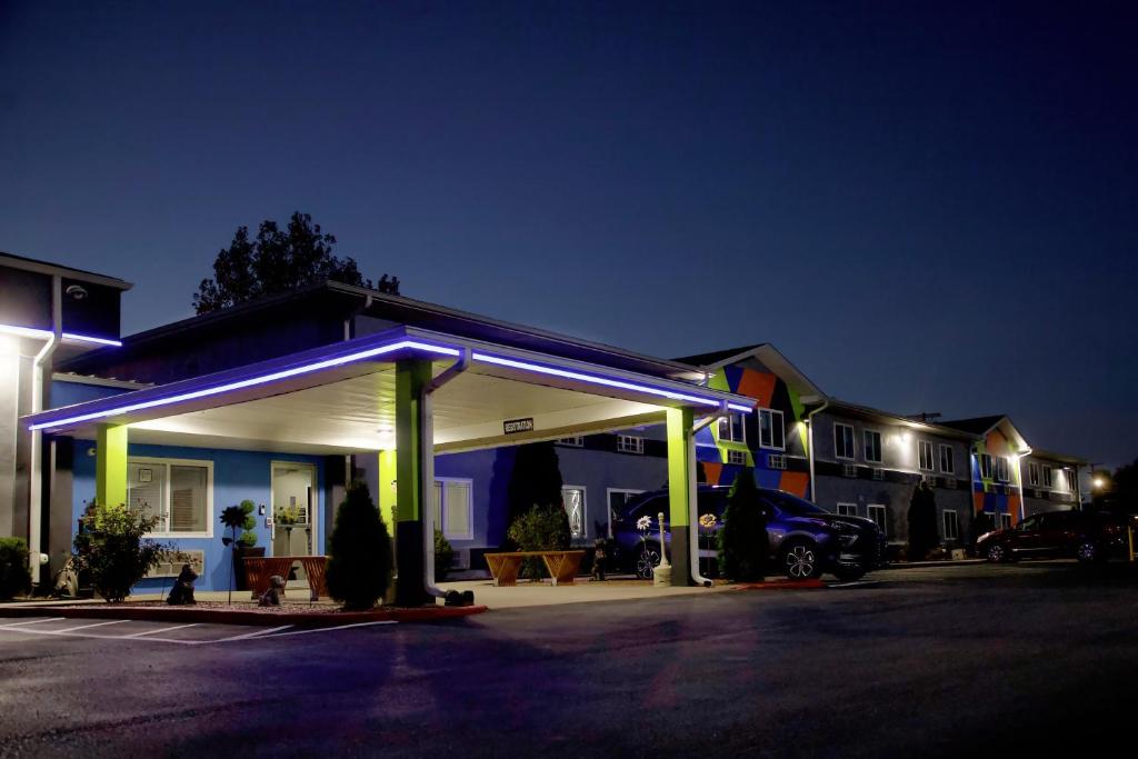 a building with a lit up garage at night at Express Inn Parsons in Parsons