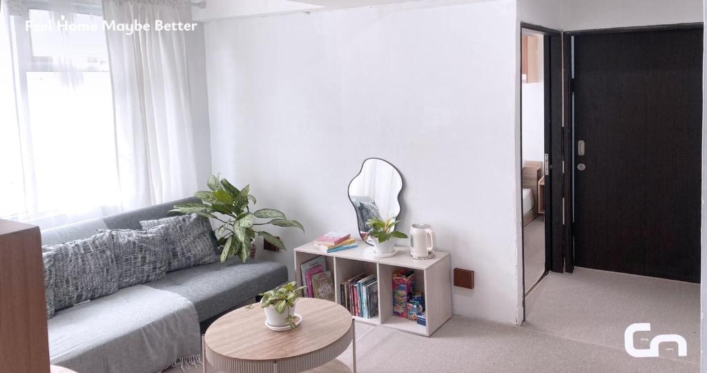 a living room with a couch and a mirror at Jarrdin Apartment by CozyNest Syariah in Bandung