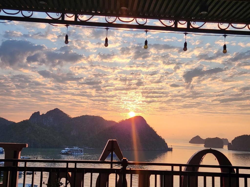 a view of the sunset from a cruise ship at Sunrise Ocean Viewpoint Hotel in Cat Ba