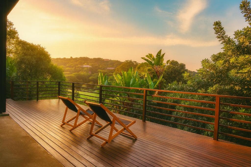 two chairs sitting on top of a wooden deck at Zimbali Emerald Eden in Ballito