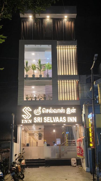 a building with a sign on the side of it at sri selvaas inn in Kanchipuram
