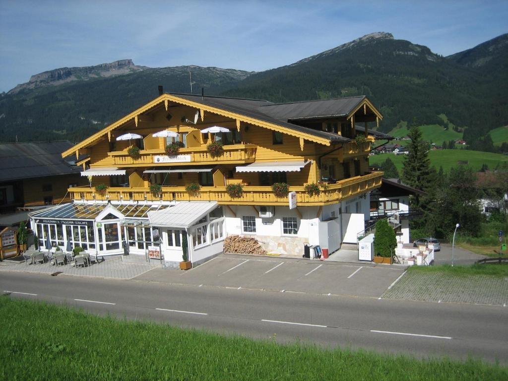 a large building on the side of a road at Ferienwohnungen Fellhornblick in Riezlern
