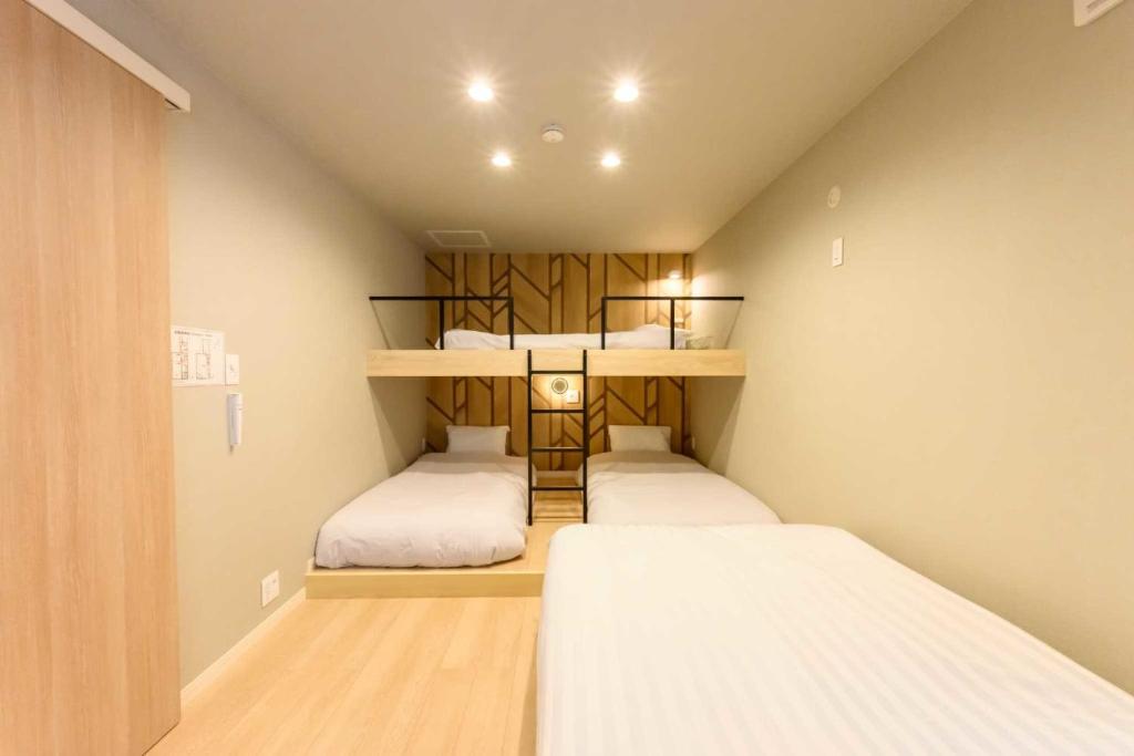 Ένα ή περισσότερα κρεβάτια σε δωμάτιο στο Darin大濠公園北