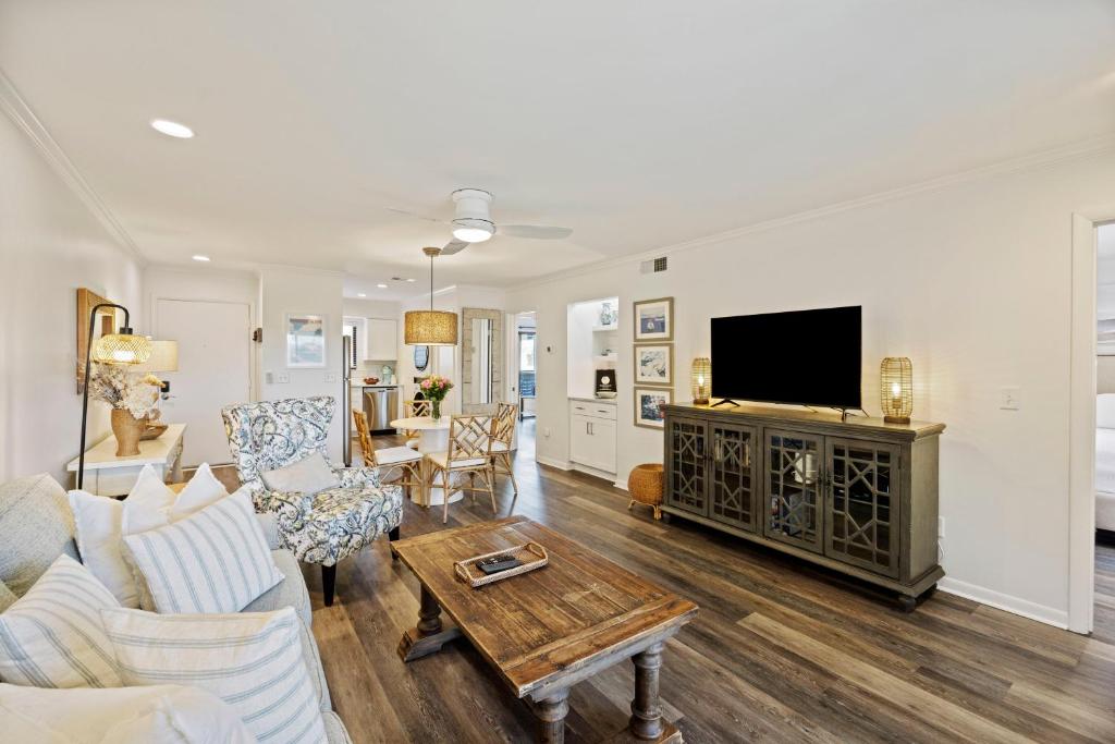 a living room with a couch and a tv at MWV2063: 2063 Marsh Walk Villa in Seabrook Island