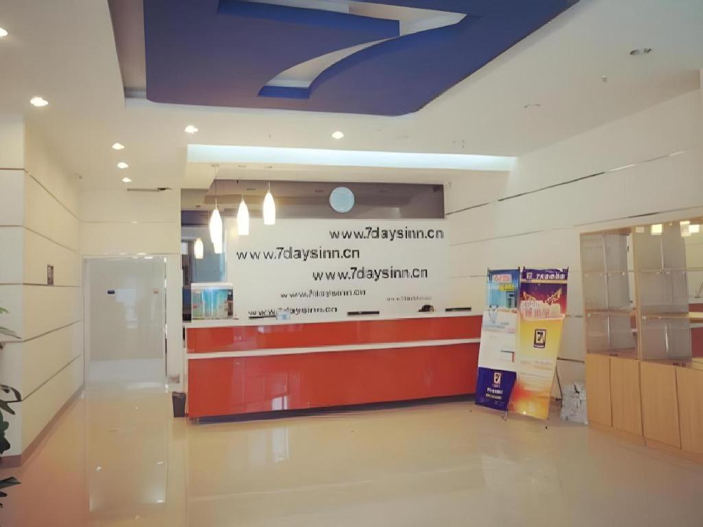 a lobby of a shopping mall with a sign on the wall at 7 Days Inn Korla Passenger Station in Bayingholin
