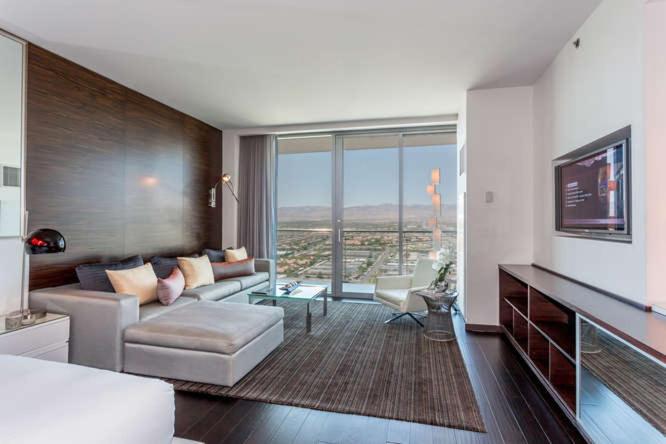 a living room with a couch and a tv at Palms place 51st floor & strip view in Las Vegas