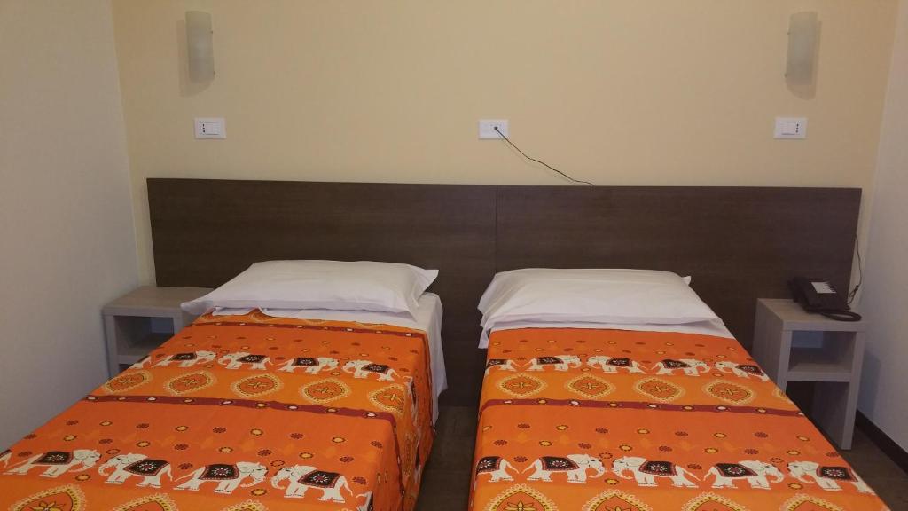 Postel nebo postele na pokoji v ubytování Hotel Tommaseo