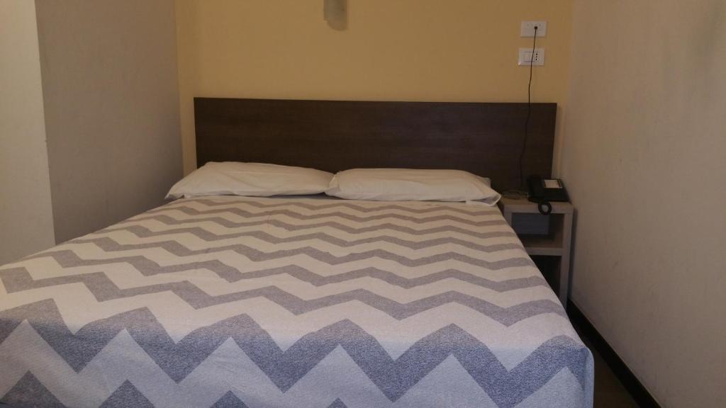 Postel nebo postele na pokoji v ubytování Hotel Tommaseo
