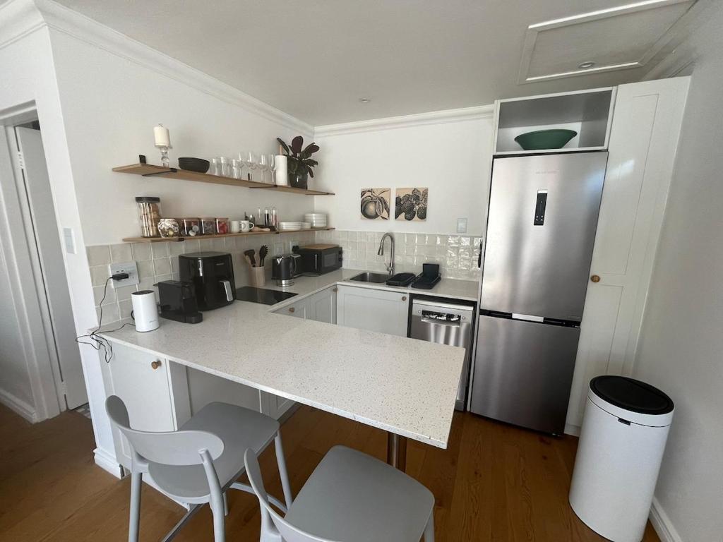 een keuken met een aanrecht en een koelkast bij The Sultan Cottage in Stellenbosch