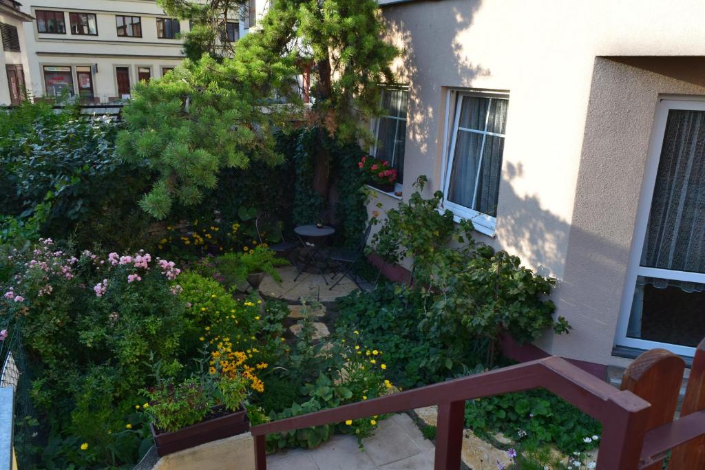 a garden in front of a building with flowers at Apartment Andre in Uherské Hradiště
