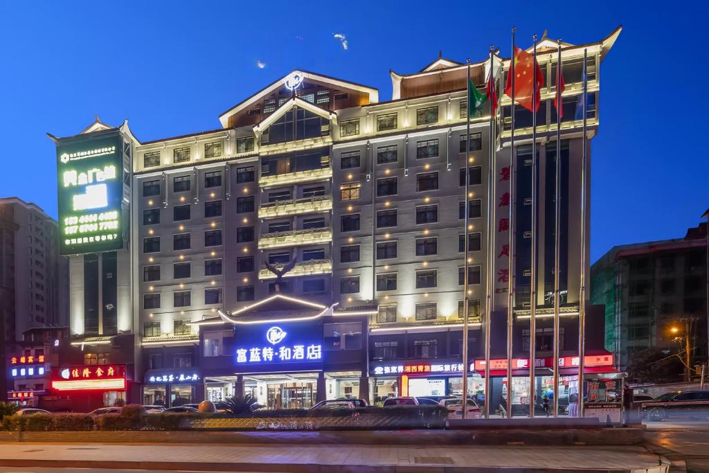 Un gran edificio con un cartel en una ciudad. en The Sky Gate Hotel-Free pick-up-Free Laundry-- At the Gate of Tianmen Peak Cableway, en Zhangjiajie