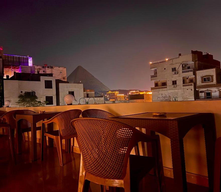 a table and chairs with a view of the pyramids at pyramids dreams in Cairo