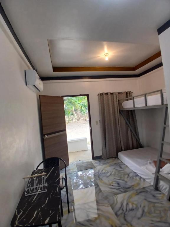 a small room with a bed and a bunk bed at correashomestay in Coron
