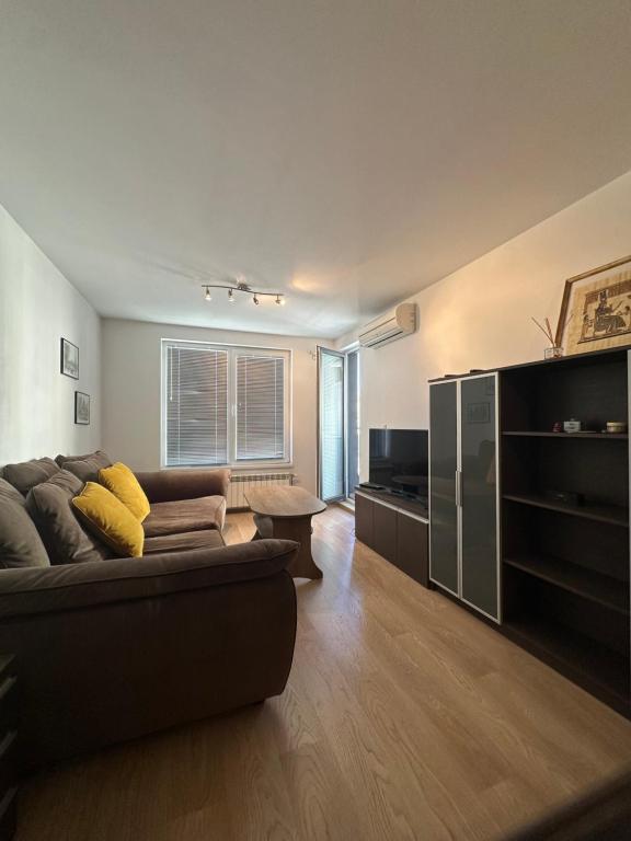 a living room with a couch and a table at GALAXY apartment in Sofia