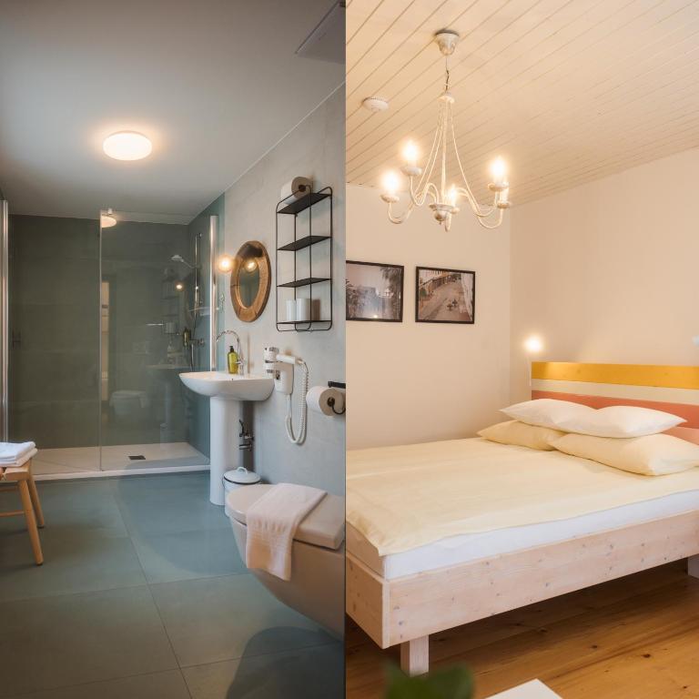 a bedroom and a bathroom with a bed and a sink at Wanderlust Boutique Rooms in Bad Goisern