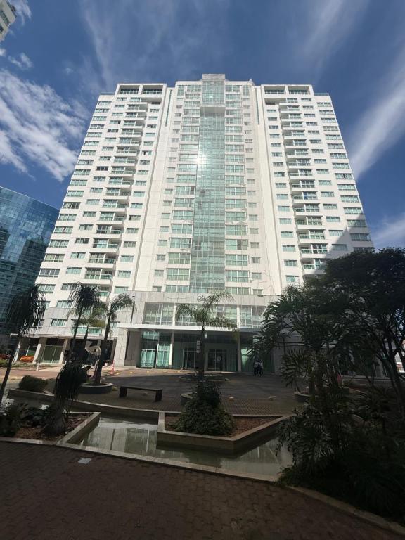 ein großes weißes Gebäude mit Bäumen davor in der Unterkunft Saint Moritz Hotel - ALM hospedagens - Flat Particular 2 in Brasilia