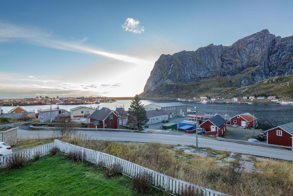 a small town with a body of water and a mountain at Valen Retro Home, Reine in Reine