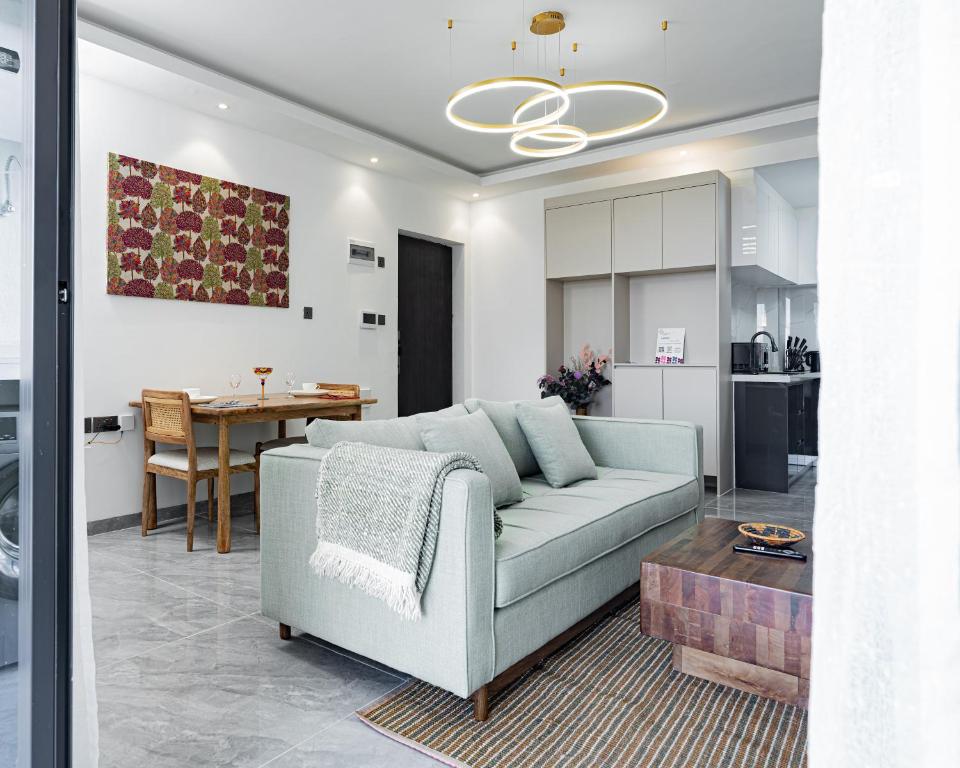 a living room with a couch and a table at Diamond Ivy Two Bedroom Apartment, Swimming pool, gym, workspace ,Wonderiss Homes Kileleshwa Living in Nairobi