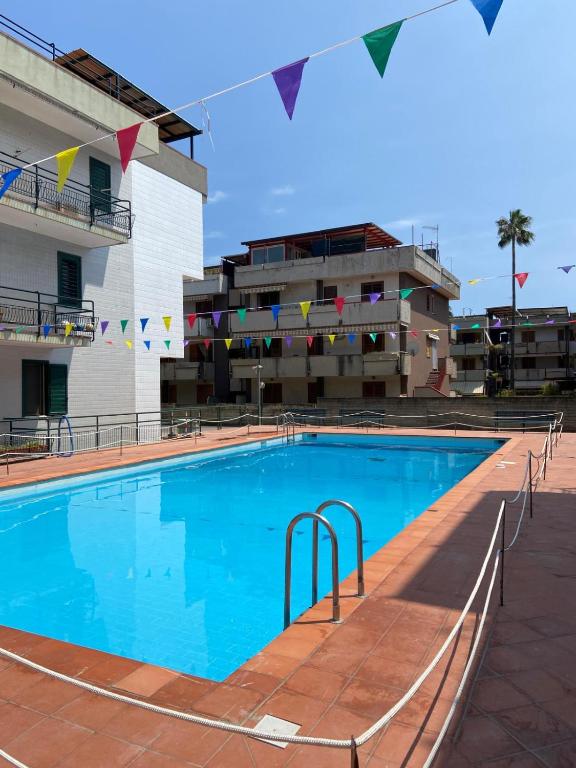 a large swimming pool in front of a building at Crateri e coralli in Mascali