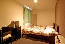 Postel nebo postele na pokoji v ubytování Sakura Hotel Oami