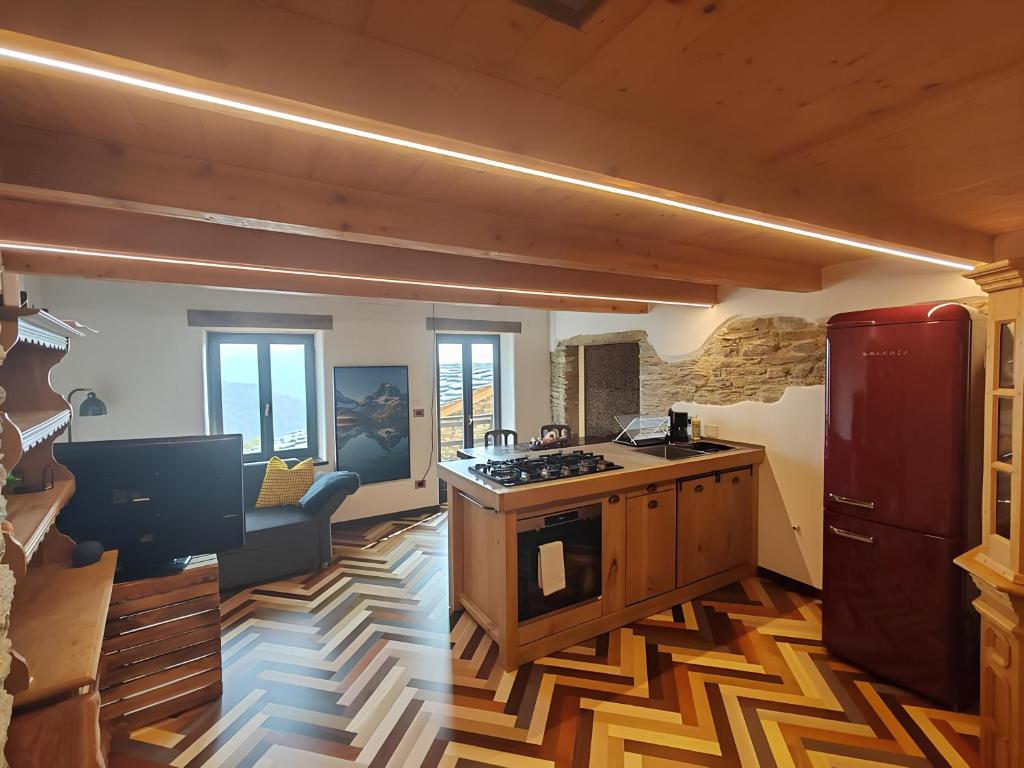 a kitchen with a stove top oven in a room at Chalet La montagne enchantée in San Damiano Macra