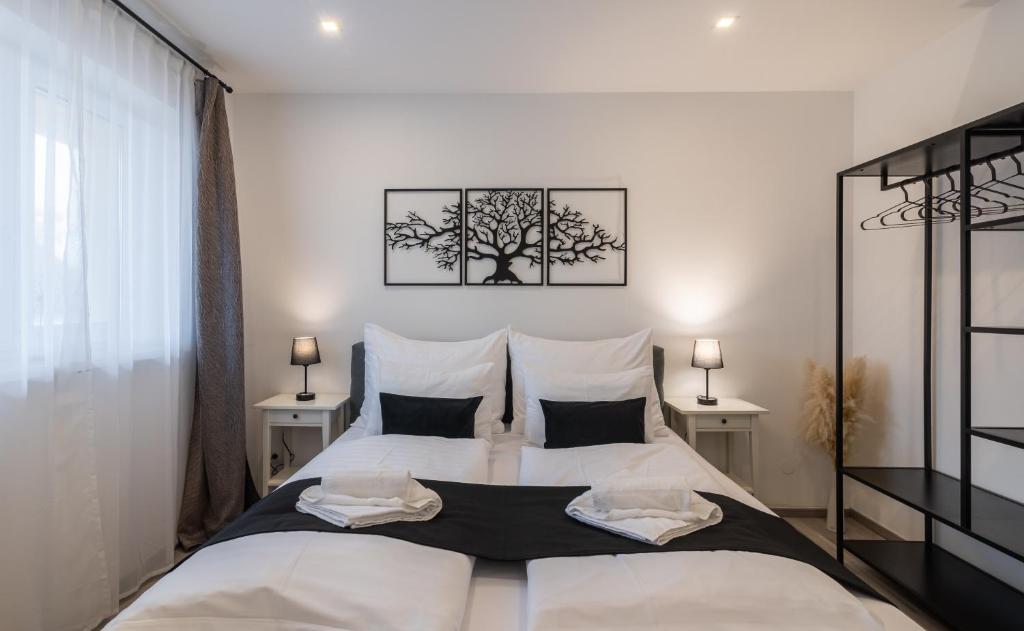 a bedroom with a large bed with two pillows at Secret Collection Thermenresort in Frauenkirchen
