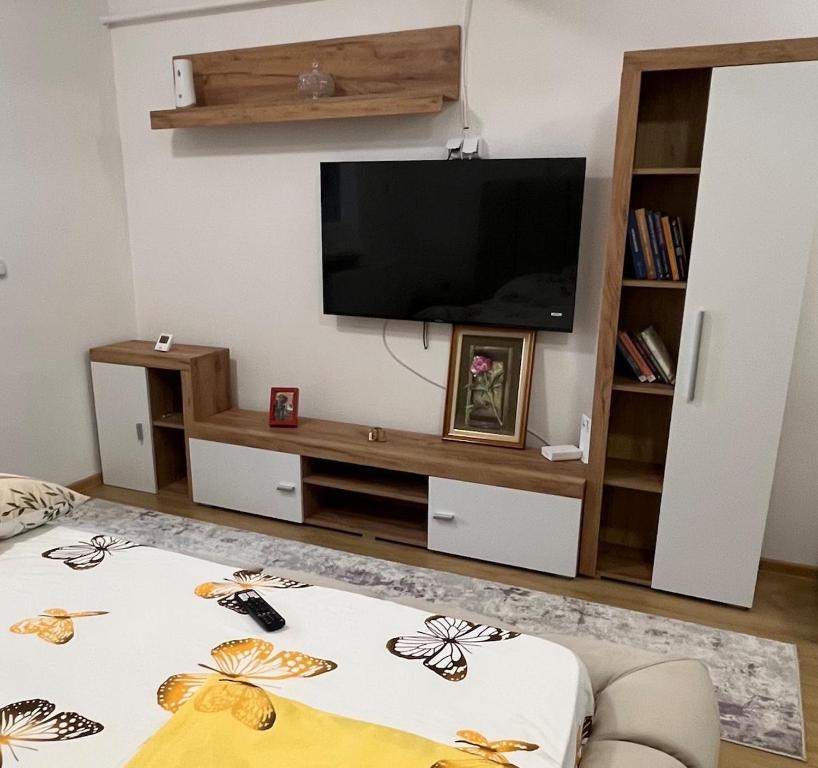 a living room with a flat screen tv on a wall at DecoStudio in Craiova