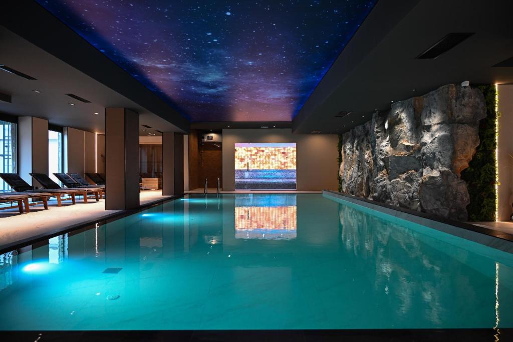 a swimming pool in a hotel with a star ceiling at Apartmani Aurora Zlatibor in Zlatibor
