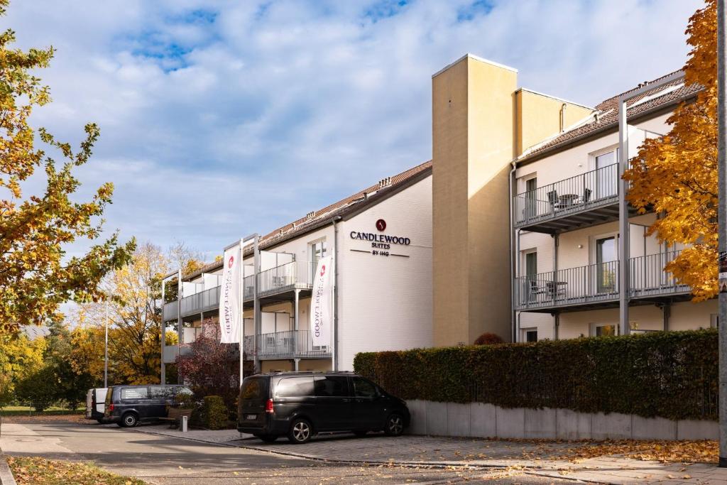 a building with a car parked in front of it at Candlewood Suites Fürth by IHG in Fürth