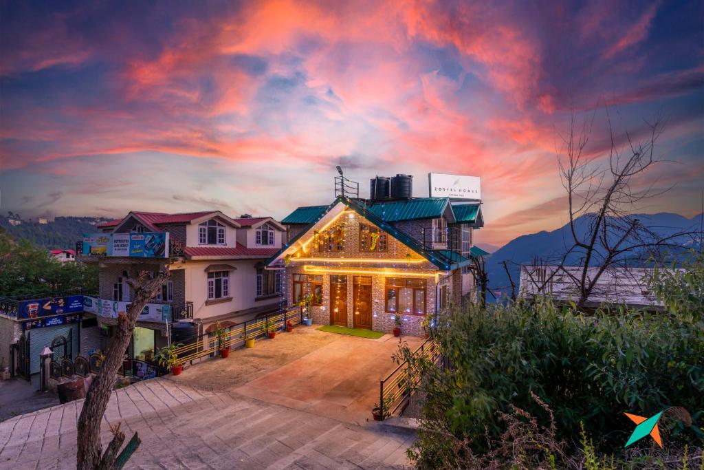 a house with lights on the front of it at Zostel Homes Shoghi, Shimla in Shogi