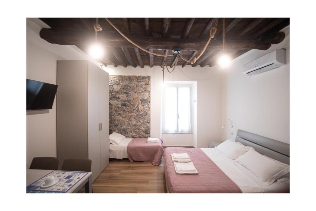 a bedroom with two beds and a television in it at Matt house in La Spezia