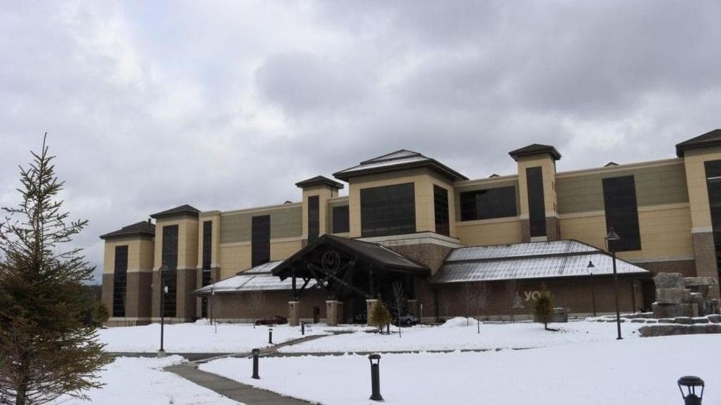 a large building with snow in front of it at YO1 Longevity & Health Resorts, Catskills in Monticello