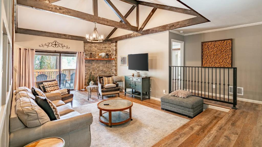 a living room with a couch and a table at Walk to Lake 7BDR HotTub Movie Theater GameRoom Dawn and Dusk by AvantStay in Big Bear Lake