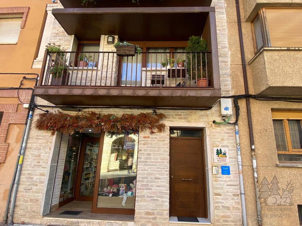 ein Gebäude mit einem Balkon und einem Fenster in der Unterkunft EL DESCANSO DE PINARES - VuT en Huerta de Rey in Huerta del Rey