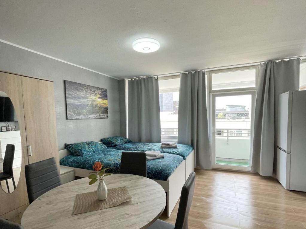 a bedroom with a bed and a table in it at Work & Stay in Neuss in Neuss