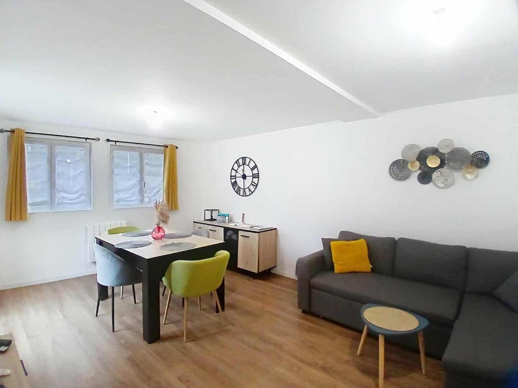 a living room with a couch and a table at Appartement Criel-sur-Mer in Criel-sur-Mer
