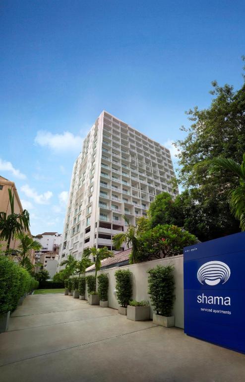 a tall building with a sign in front of it at Shama Sukhumvit Bangkok in Bangkok