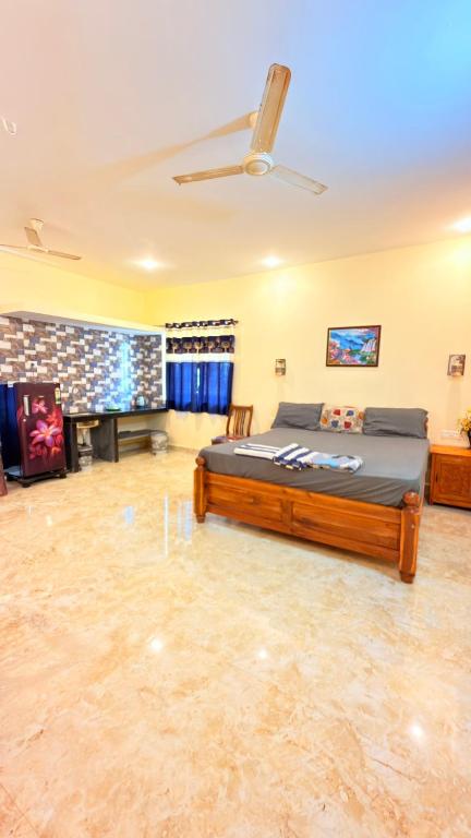 a large bedroom with a bed and a fireplace at SAI HOMESTAY in Agonda